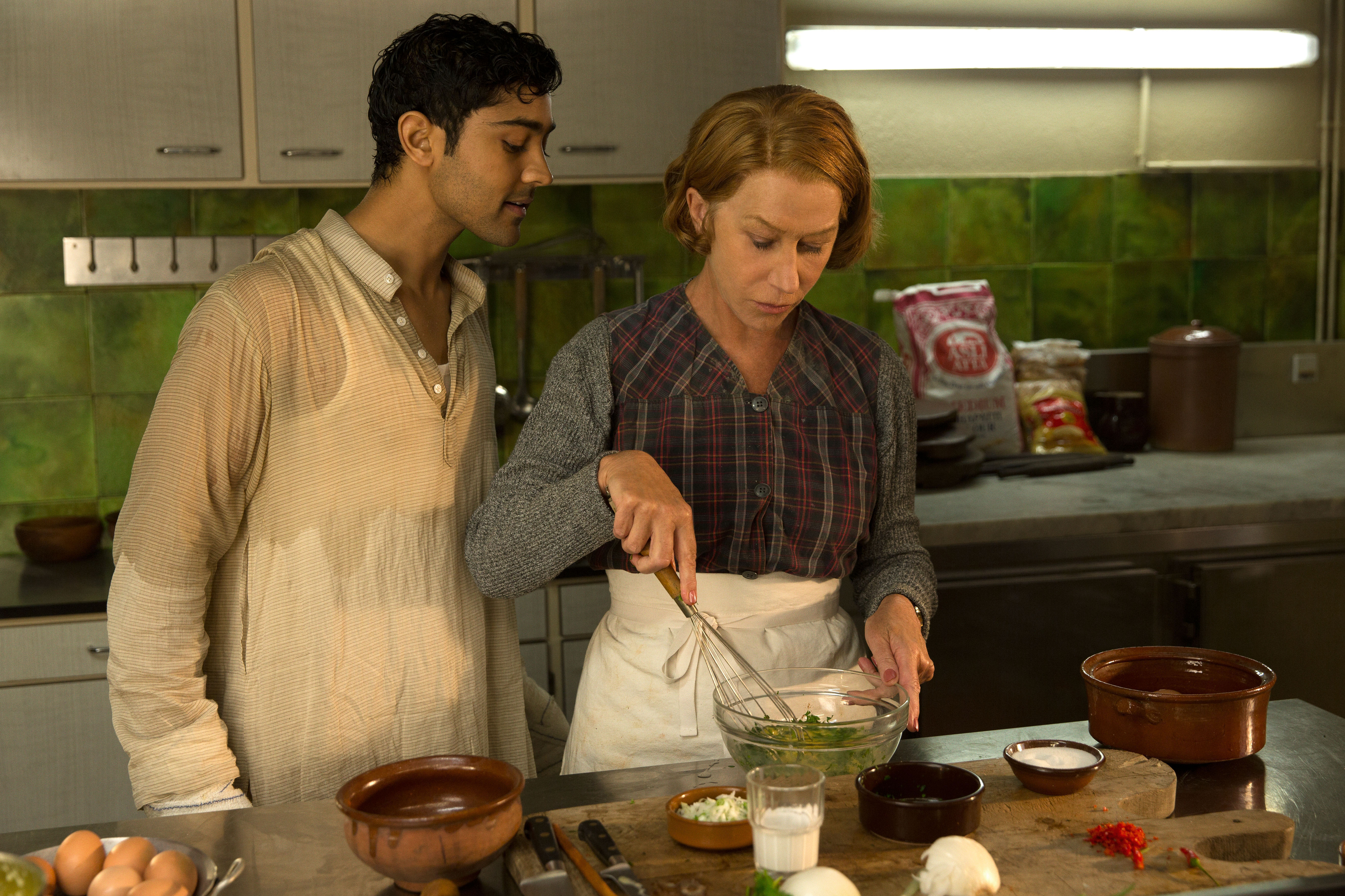 HFJ-0068r When Hassan Kadam (Manish Dayal) and his family move from India to a village in the South of France, they open a restaurant and encounter Madame Mallory, (Academy Award®-winner Helen Mirren) the chef proprietress of a classical Michelin-starred French restaurant across the street. Cultures collide, but they eventually find common ground through their love of cooking, in DreamWorks Pictures’ charming film, “The Hundred-Foot Journey.” Based on the novel “The Hundred-Foot Journey” by Richard C. Morais, the film is directed by Lasse Hallström. The producers are Steven Spielberg, Oprah Winfrey and Juliet Blake. Photo: François Duhamel ©2014 DreamWorks II Distribution Co., LLC. All Rights Reserved.