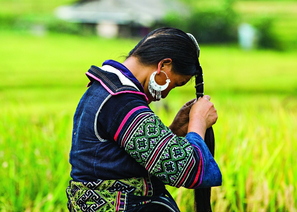 MANDATORY CREDIT: Réhahn Photography/REX Shutterstock. Only for use in this story. Editorial Use Only. No stock, books, advertising or merchandising without photographer's permission Mandatory Credit: Photo by Réhahn Photography/REX Shutterstock (5064716m) A woman of the Hmong tribe braiding her hair in the village of Sapa Smiling faces of North Vietnam, Vietnam - Aug 2015 FULL COPY: http://www.rexfeatures.com/nanolink/r1mu A photographer has captured a series of striking portraits of Northern Vietnam's ethnic tribes. French photographer Réhahn captured the images on a recent roadtrip through Northern Vietnam's stunning mountains. There are many different ethnic tribes in the Northern Vietnam region, each with a unique traditional clothing and a unique language. In the pictures stunning portraits can be seen of the locals, dressed in their unique colours and textile prints.