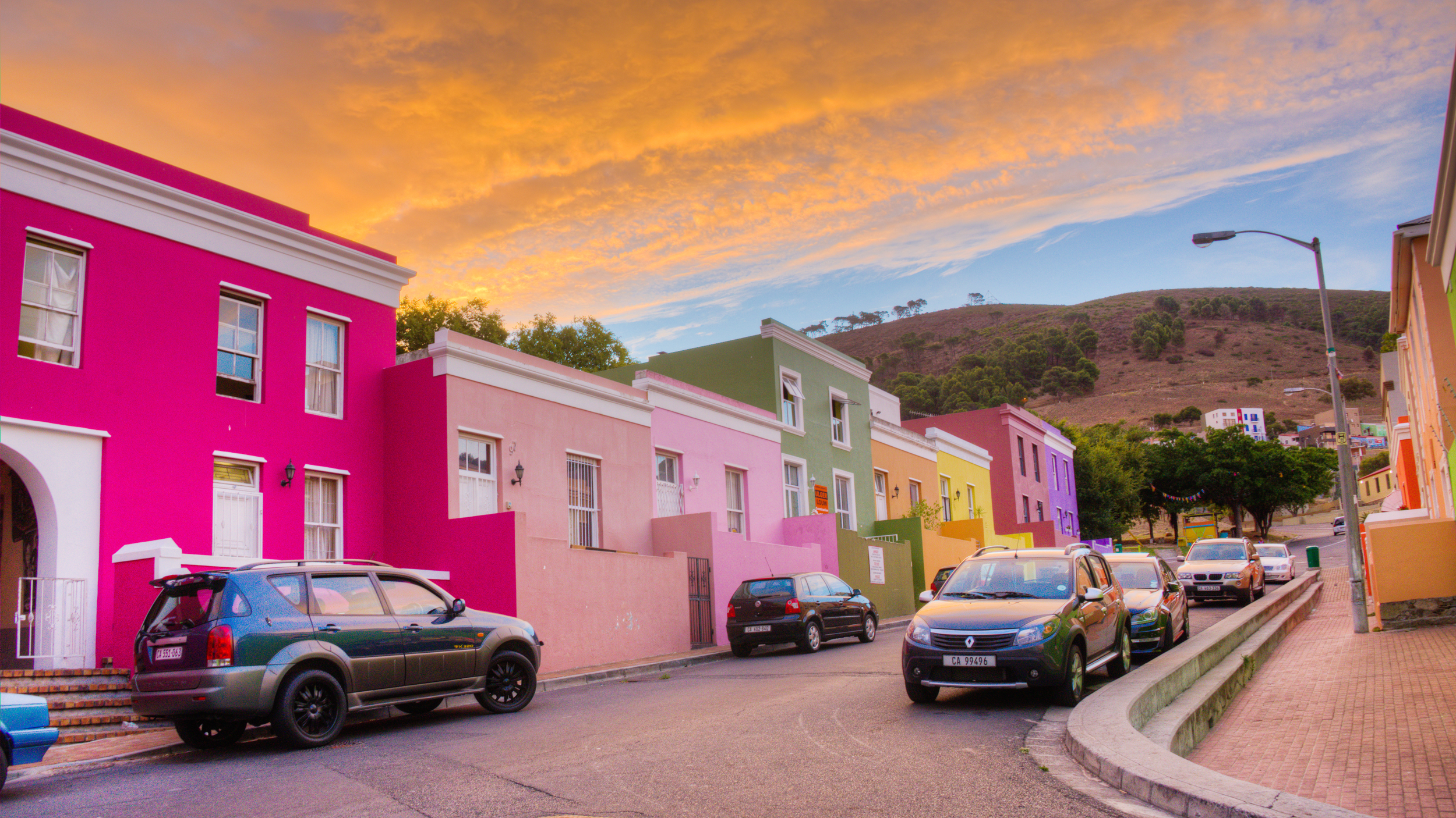 Bo-kaap in the old Malay quarter of Cape Town South Africa with Signal Hill behind the colorful homes just before sunset